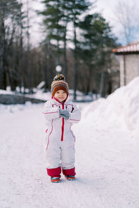 Full length of woman standing on snow