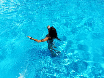 High angle view of woman swimming in pool