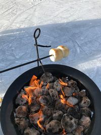 High angle view of marshmallow over fire pit