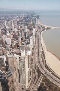 High angle view of buildings and sea against sky