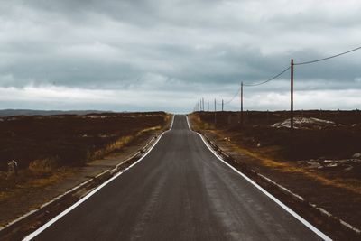 Road amidst landscape against sky