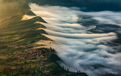 Scenic view of landscape against cloudy sky