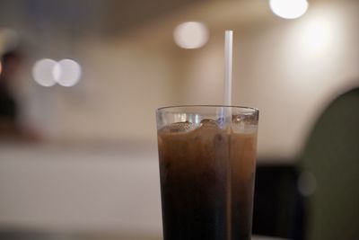 Close-up of  ice coffee drink in glass on table