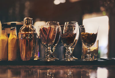 Close-up of wine glasses on table