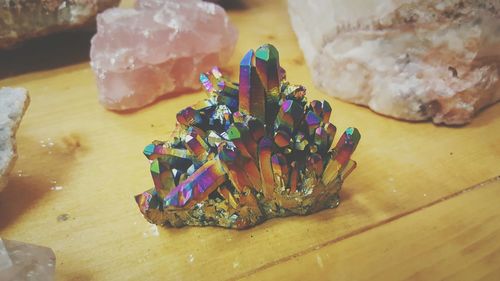 Close-up of colorful crystal on wooden table