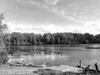 Swan swimming in lake against sky