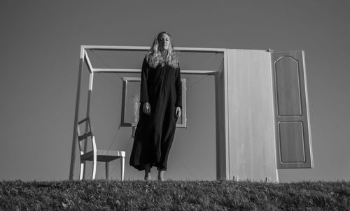Woman standing against wall