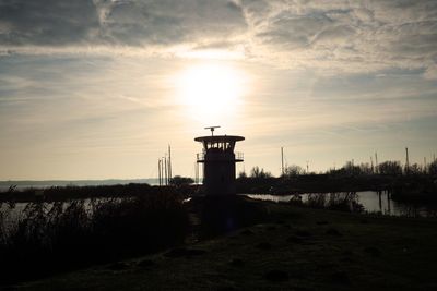 Lighthouse against sky during sunset