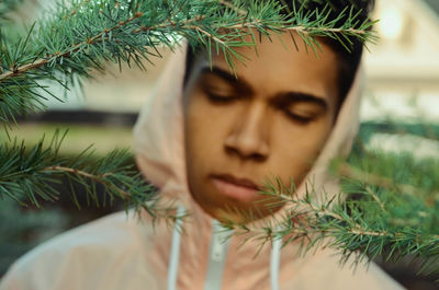 Close-up portrait of young woman with christmas tree