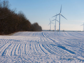 Scenic view of snow covered field against clear sky