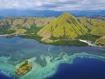 Scenic view of sea and mountains against sky