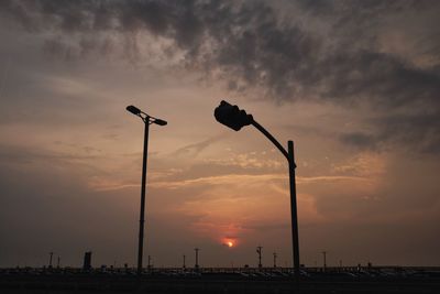 Low angle view of silhouette street light against sky during sunset