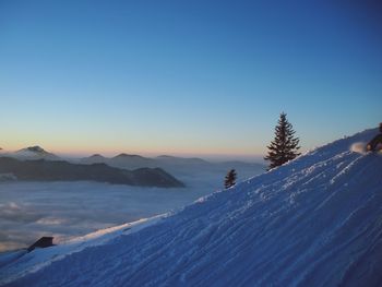 Scenic view of snowcapped mountains against clear blue sky