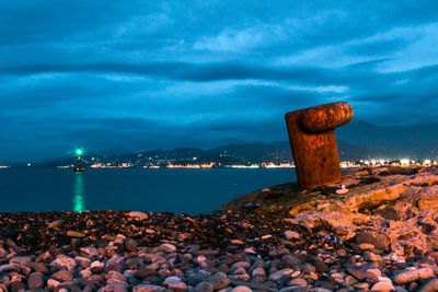 Rocks by sea against sky