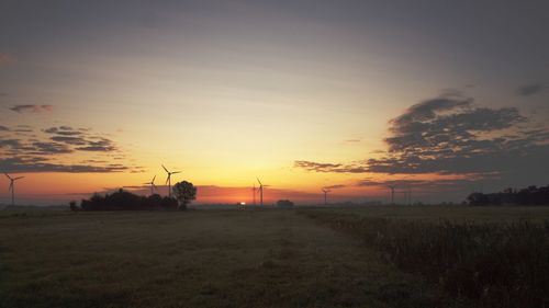 Scenic view of field against sky during sunset