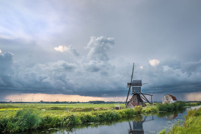 Windmill with storm clouds over the dutch landscape