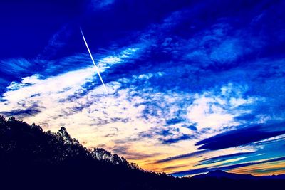 Low angle view of vapor trails in sky