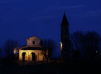 Illuminated building against sky at night