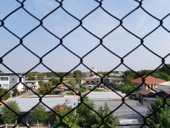 Buildings seen through chainlink fence