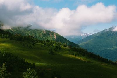 Scenic view of mountains against cloudy sky