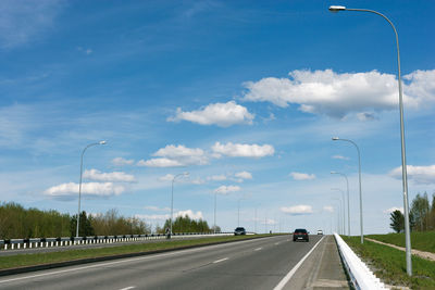 A road under the blue sky with clouds