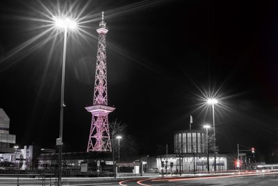 Low angle view of illuminated tower at night