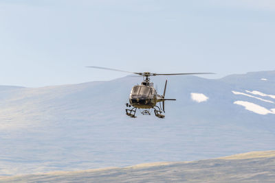 Helicopter in the sky in a wild mountain landscape