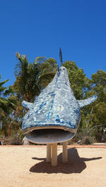 Built structure on beach against clear blue sky