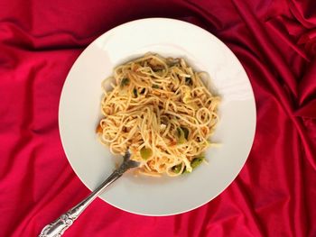 Directly above shot of noodles and rice in plate on table