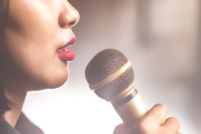 Cropped image of singer holding microphone