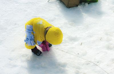 Full length of boy playing with snow