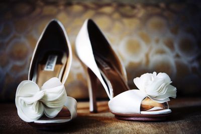 Close-up of wedding stilettos on floor