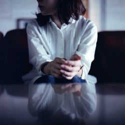 Midsection of woman sitting outdoors