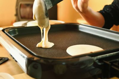 Close-up of person preparing food in kitchen