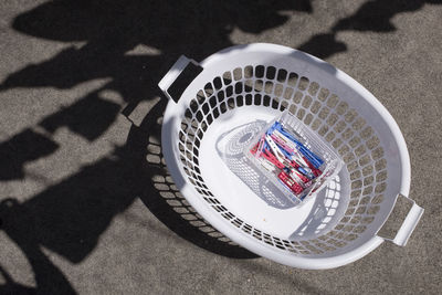 High angle view of clothespins in basket