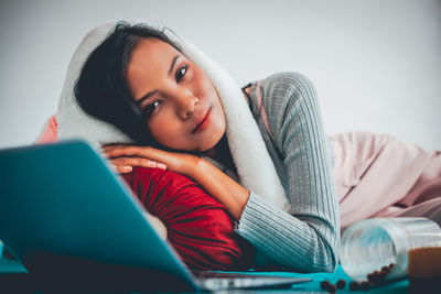 Portrait of young woman using mobile phone