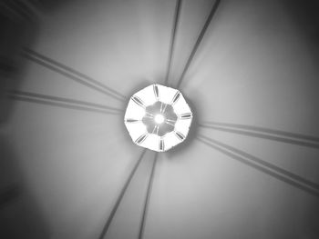 Low angle view of illuminated lamp hanging on ceiling