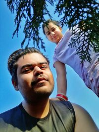 Portrait of happy friends against sky