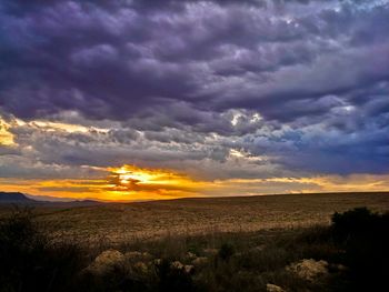 Scenic view of landscape against cloudy sky