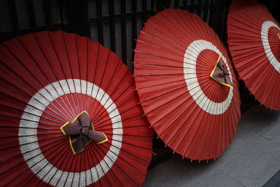 Midsection of woman with red umbrella