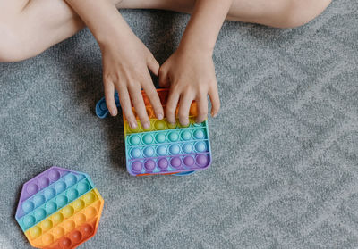 High angle view of hands playing with toy