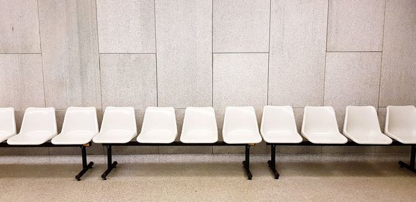 Empty chairs against wall