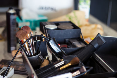 Dedicated focus make-up converter on makeup artist's table with lots of makeup artist tools.