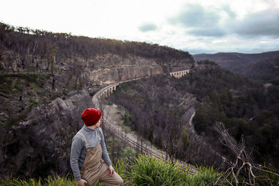 Rear view of man standing on mountain