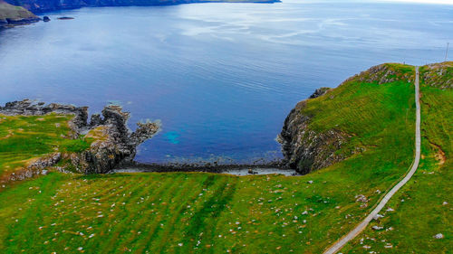 High angle view of land and sea against sky