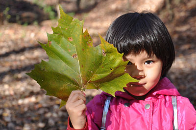 Close-up of girl holding a leaf