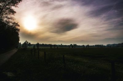 Scenic view of field against sky during sunset