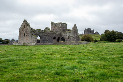 Old ruin on field against sky