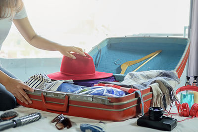 Close-up of woman packing suitcase