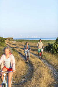 Mother with daughters cycling, oland, sweden